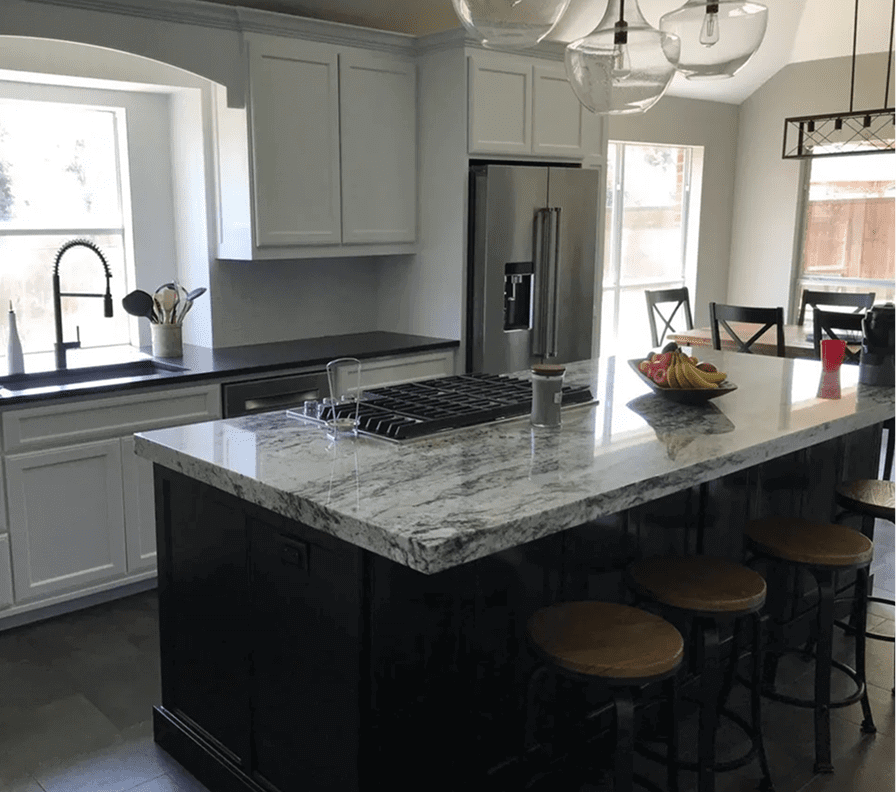 Modern kitchen with island and bar stools.